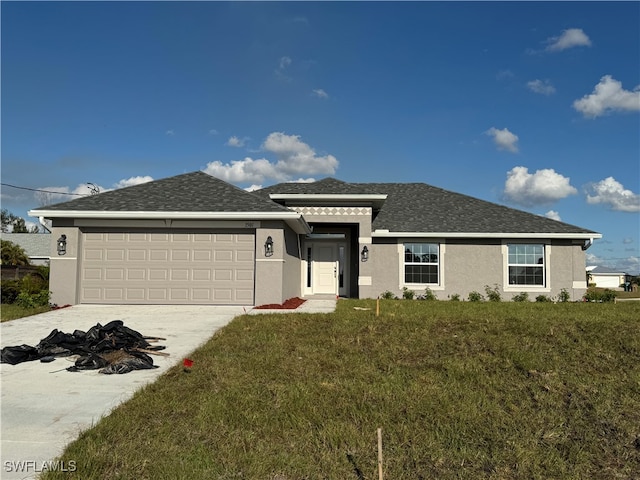 view of front of home featuring a front yard and a garage