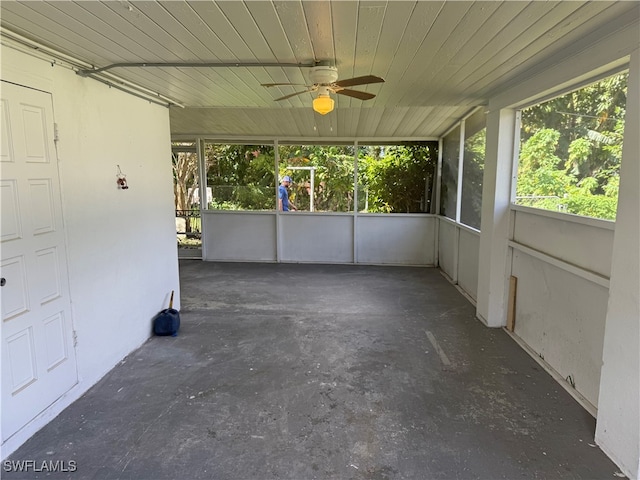 unfurnished sunroom featuring ceiling fan and wooden ceiling