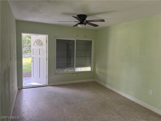 unfurnished room featuring ceiling fan and a healthy amount of sunlight