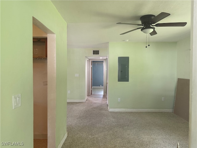 carpeted empty room with ceiling fan and electric panel