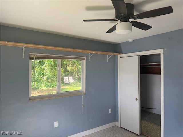 unfurnished bedroom with ceiling fan and a closet