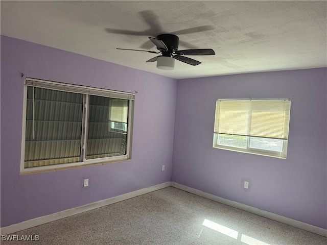 empty room featuring ceiling fan and a textured ceiling