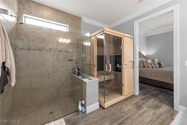 bathroom with an enclosed shower, wood-type flooring, and crown molding