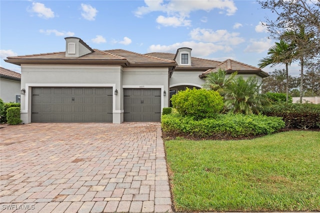 view of front of house with a garage and a front yard