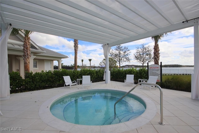 view of swimming pool featuring a patio area and a water view