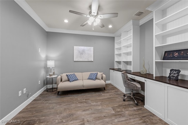 home office with hardwood / wood-style floors, built in desk, crown molding, and ceiling fan