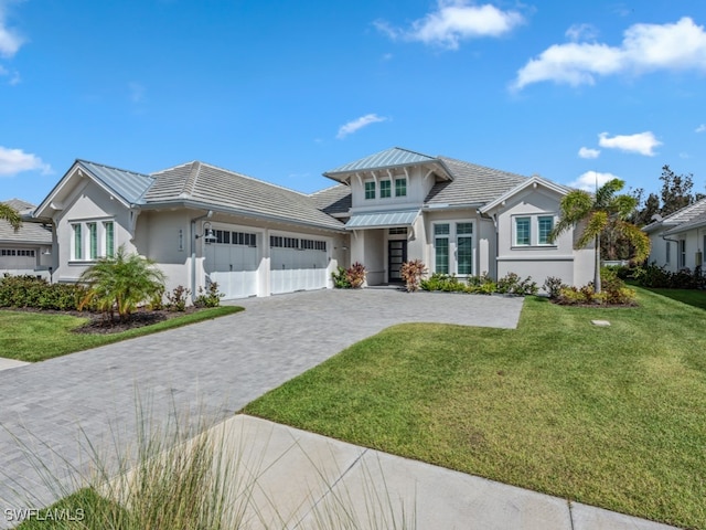 view of front of property with a front yard and a garage