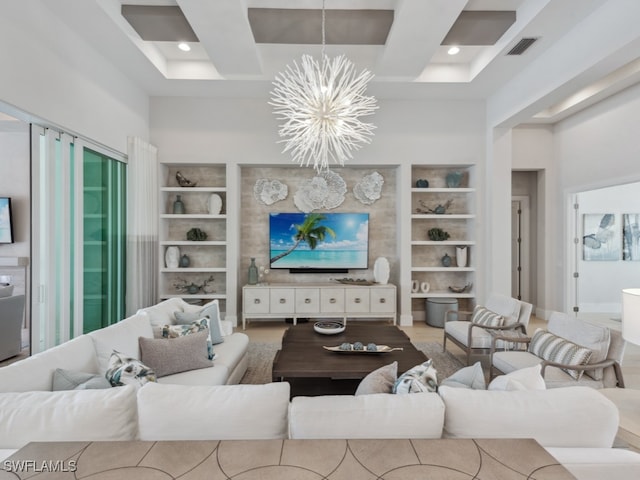 living room featuring built in features, an inviting chandelier, and beamed ceiling