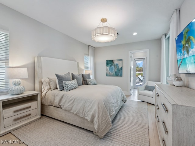 bedroom with light hardwood / wood-style flooring and access to exterior