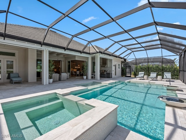 view of pool featuring an in ground hot tub, a patio area, and glass enclosure