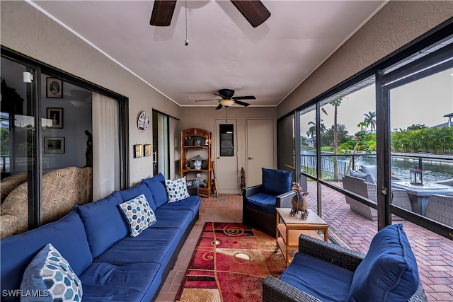 sunroom / solarium featuring ceiling fan