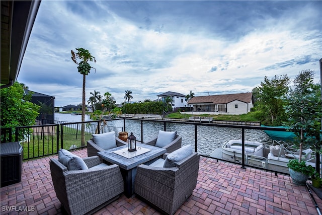 view of patio with an outdoor living space and a water view