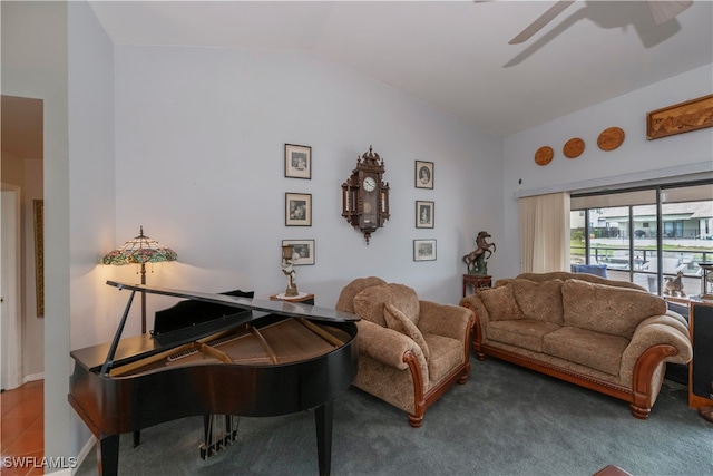 carpeted living room featuring ceiling fan and lofted ceiling