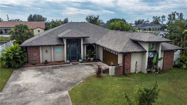 ranch-style home featuring a front yard and a garage