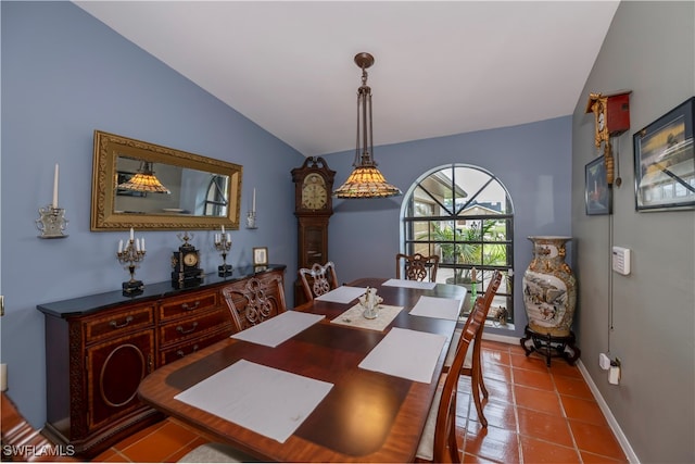 dining space featuring light tile patterned floors and lofted ceiling