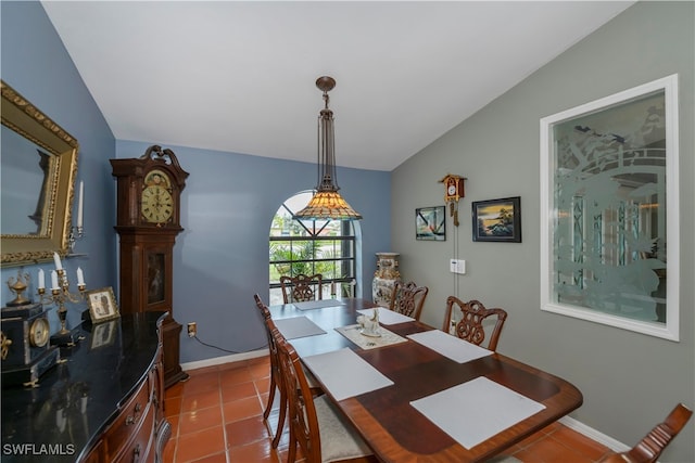 tiled dining room with lofted ceiling