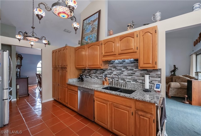 kitchen featuring lofted ceiling, backsplash, sink, decorative light fixtures, and appliances with stainless steel finishes