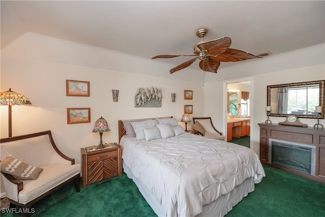 carpeted bedroom with connected bathroom and ceiling fan