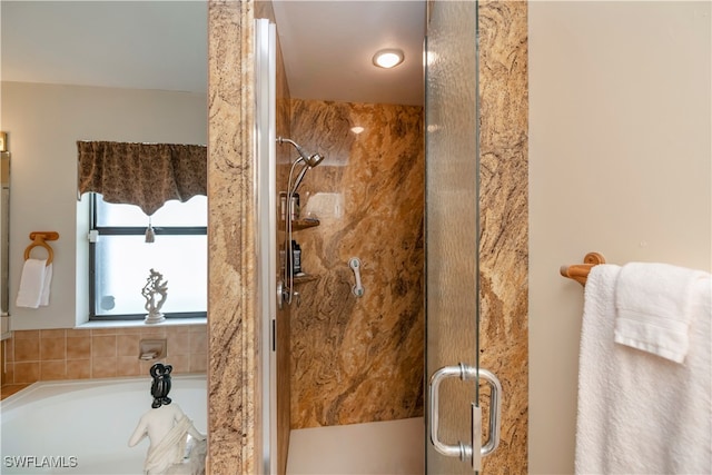 bathroom featuring separate shower and tub