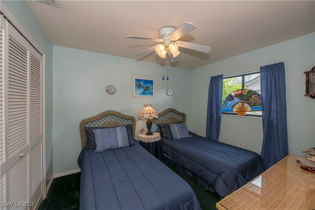 bedroom featuring a closet, dark carpet, and ceiling fan