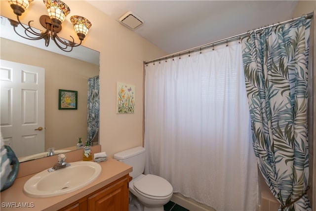 bathroom with vanity, toilet, and curtained shower