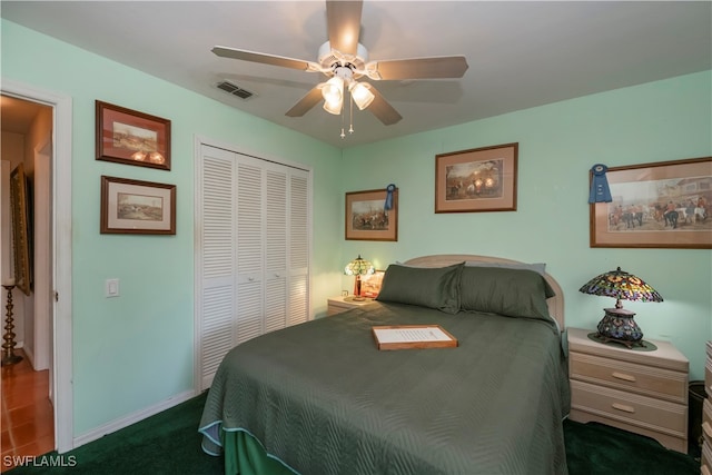 bedroom featuring dark colored carpet, a closet, and ceiling fan