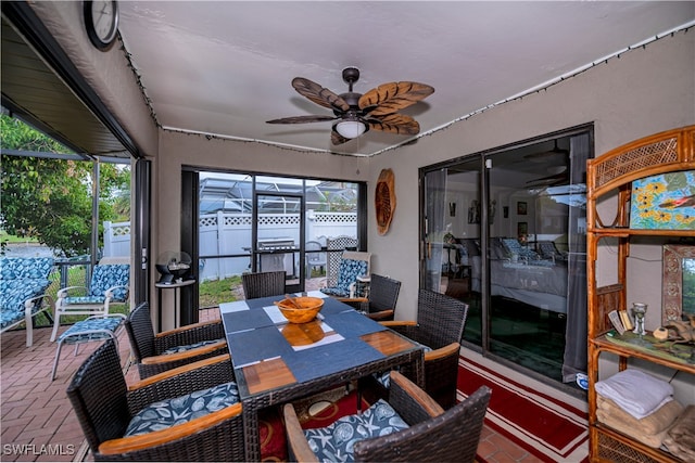 sunroom / solarium with plenty of natural light and ceiling fan