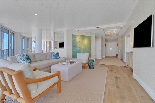 living room with light hardwood / wood-style flooring and wood ceiling