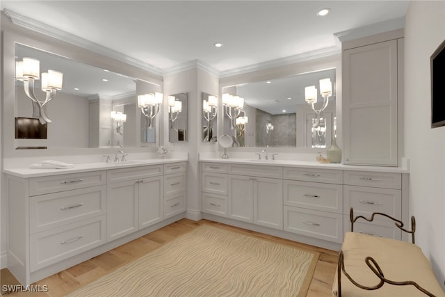 bathroom with vanity, crown molding, and wood-type flooring