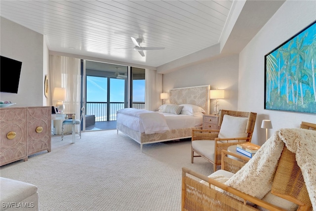 bedroom featuring access to outside, carpet floors, floor to ceiling windows, and ceiling fan