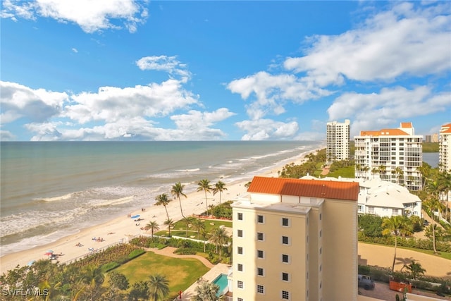 birds eye view of property featuring a water view and a beach view