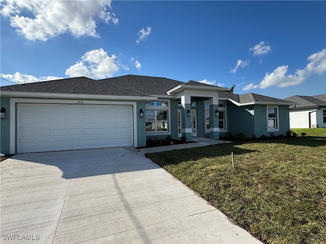 view of front of home featuring a garage and a front lawn