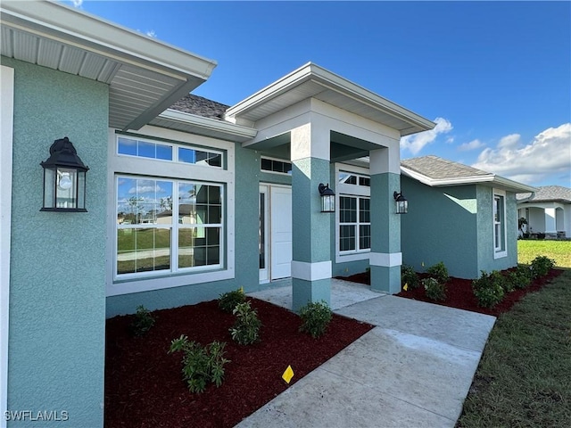 2112 NW 22nd Ave, Cape Coral, FL 33993 - property entrance featuring stucco siding and roof with shingles