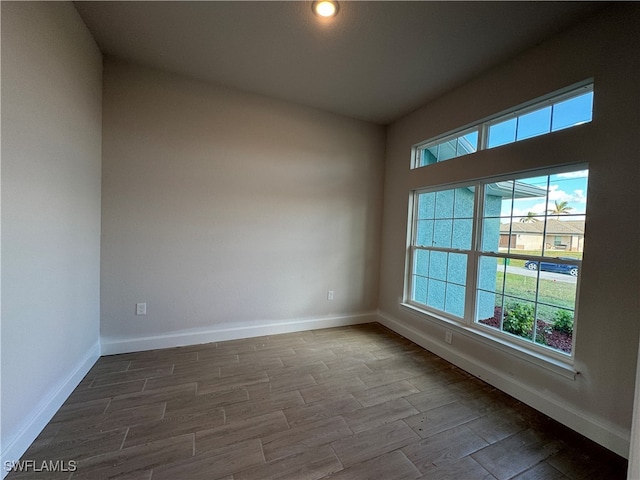 empty room featuring wood-type flooring and a wealth of natural light