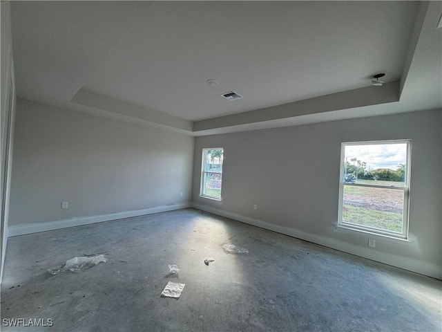 2112 NW 22nd Ave, Cape Coral, FL 33993 - empty room featuring a raised ceiling, baseboards, and concrete floors
