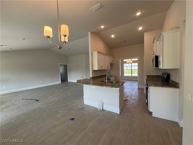 kitchen featuring white cabinetry, electric range, sink, pendant lighting, and lofted ceiling