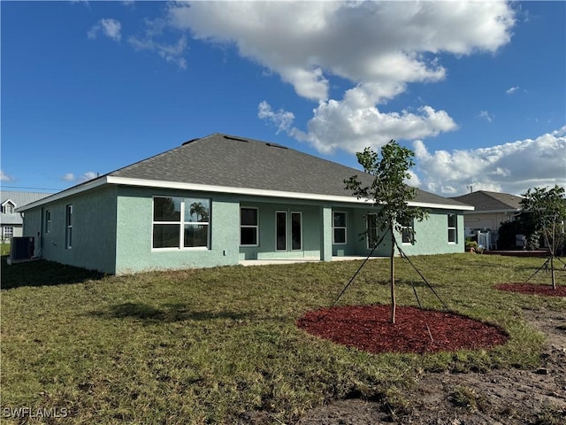 2112 NW 22nd Ave, Cape Coral, FL 33993 - rear view of house with stucco siding, a yard, central AC, and a shingled roof