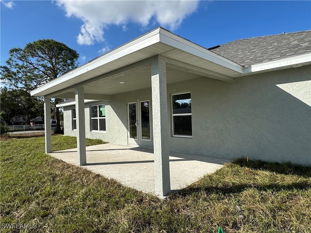 exterior space featuring a patio area and a lawn