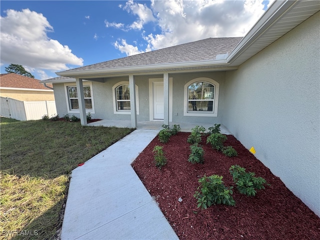 property entrance featuring a lawn