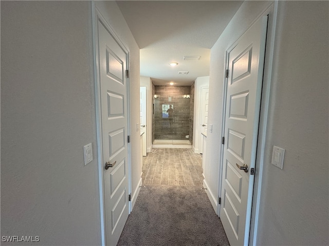 hallway with carpet flooring