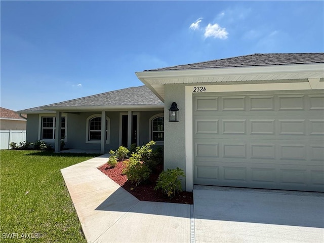 2324 Jacaranda Pkwy W, Cape Coral, FL 33993 - ranch-style house featuring a garage, a front yard, roof with shingles, stucco siding, and driveway