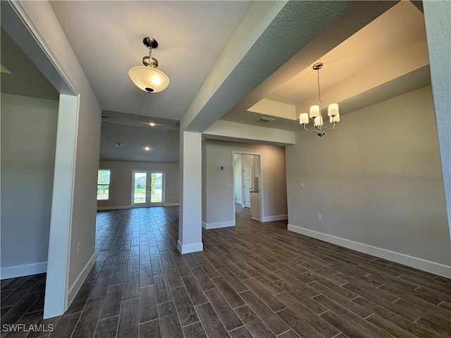 2324 Jacaranda Pkwy W, Cape Coral, FL 33993 - interior space with a raised ceiling, a chandelier, baseboards, visible vents, and dark wood-style floors