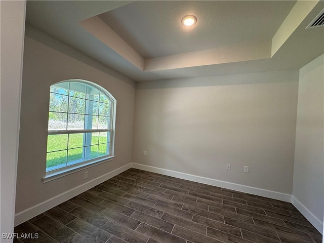 2324 Jacaranda Pkwy W, Cape Coral, FL 33993 - unfurnished room featuring baseboards, wood tiled floor, a raised ceiling, and visible vents