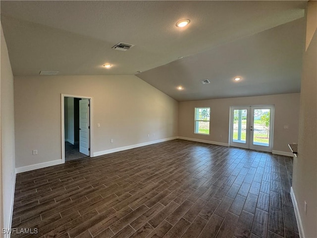 2324 Jacaranda Pkwy W, Cape Coral, FL 33993 - spare room with visible vents, baseboards, dark wood-style flooring, and vaulted ceiling