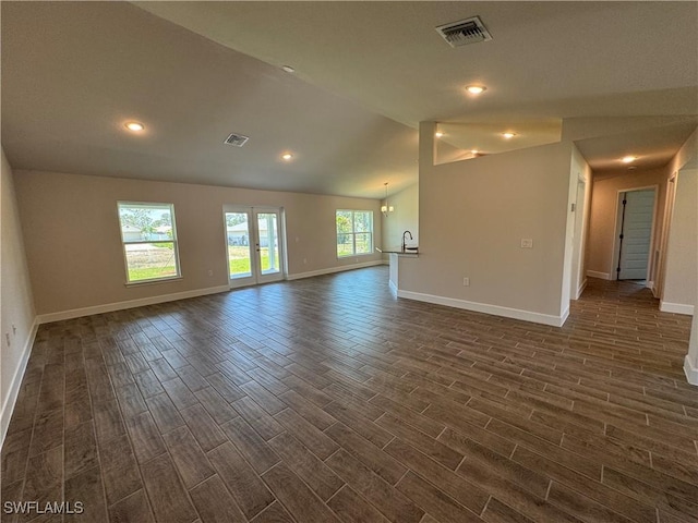 2324 Jacaranda Pkwy W, Cape Coral, FL 33993 - unfurnished room with vaulted ceiling, baseboards, dark wood-type flooring, and visible vents