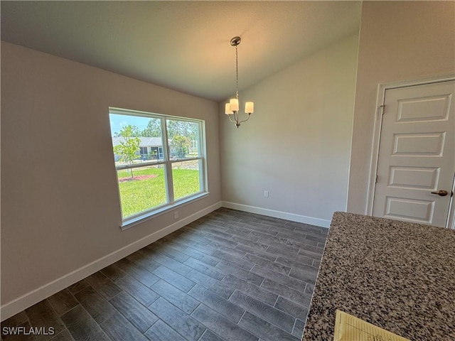 2324 Jacaranda Pkwy W, Cape Coral, FL 33993 - unfurnished dining area featuring baseboards, an inviting chandelier, dark wood finished floors, and lofted ceiling