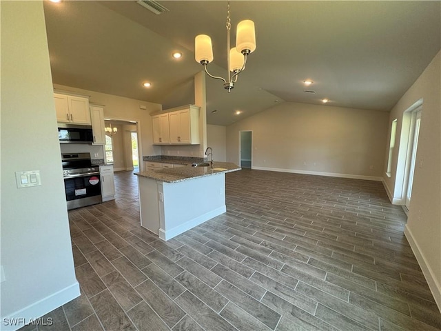 2324 Jacaranda Pkwy W, Cape Coral, FL 33993 - kitchen with appliances with stainless steel finishes, baseboards, white cabinets, lofted ceiling, and open floor plan
