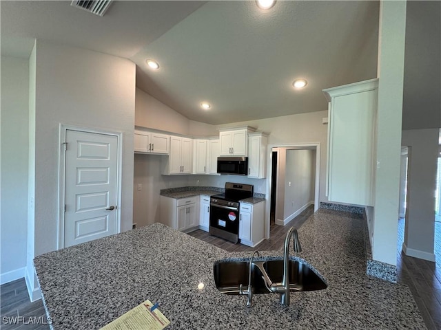 2324 Jacaranda Pkwy W, Cape Coral, FL 33993 - kitchen with vaulted ceiling, stainless steel electric range, a sink, dark stone counters, and dark wood-type flooring