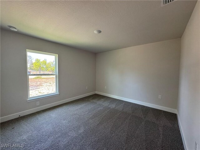 2324 Jacaranda Pkwy W, Cape Coral, FL 33993 - unfurnished room with a textured ceiling, baseboards, and dark carpet