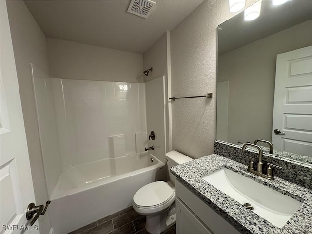 2324 Jacaranda Pkwy W, Cape Coral, FL 33993 - bathroom with a textured wall, wood finish floors, vanity, toilet, and visible vents
